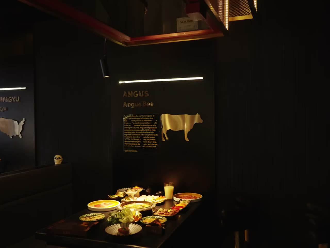 Guests at a Yumiyaki table, the sukiyaki pot steaming between them