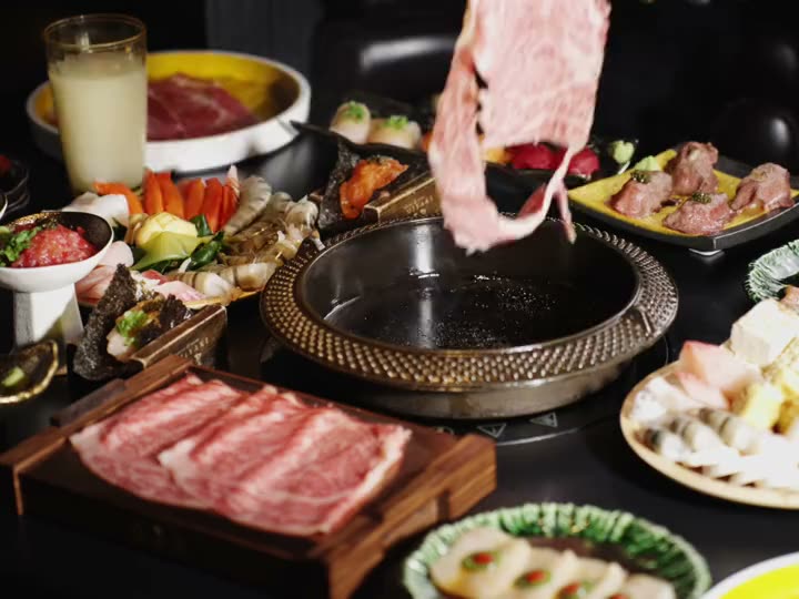 A slice of A5 wagyu laid into the iron pot