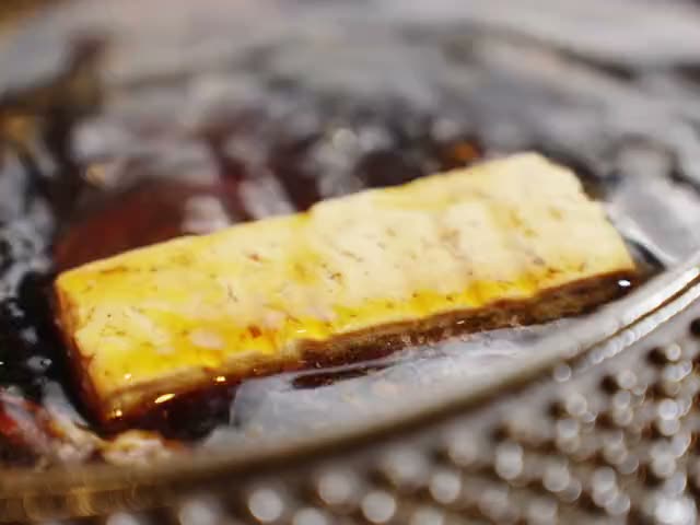 Tofu cooking in sukiyaki sauce